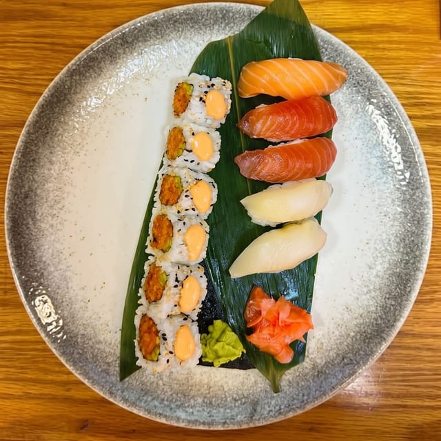 Nigiri Sushi and 1 Spicy Salmon or Spicy Tuna Roll.
